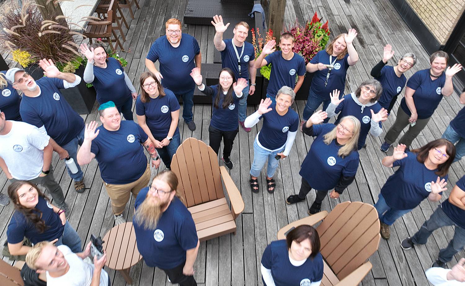 Aerial image of Isthmus team members standing on the Terrace wearing matching navy blue t-shirts