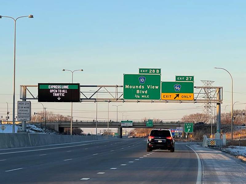 Car on I-35W with signs